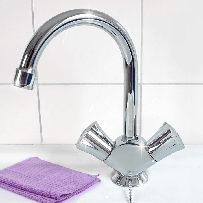 Wiped chrome faucet with a purple cloth beside it