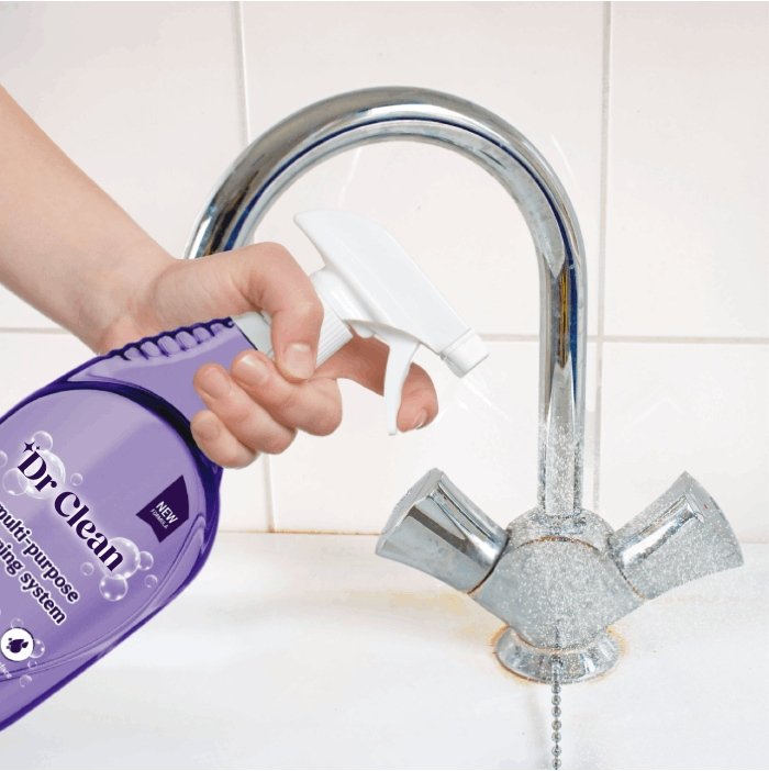 Spraying a chrome faucet with Dr Clean